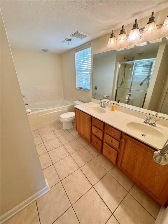 full bathroom with vanity, a textured ceiling, independent shower and bath, tile patterned flooring, and toilet