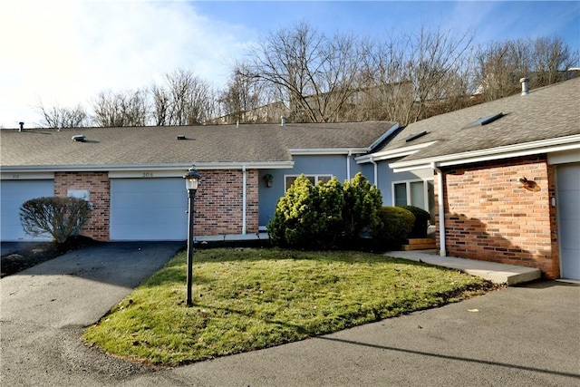 single story home with a garage and a front lawn