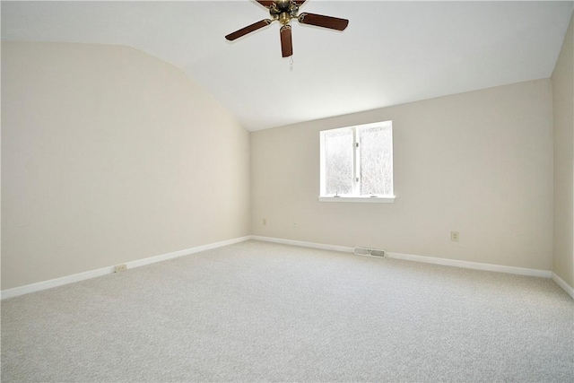 empty room featuring carpet floors, ceiling fan, and lofted ceiling