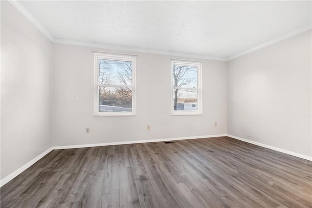 empty room with dark hardwood / wood-style floors and ornamental molding