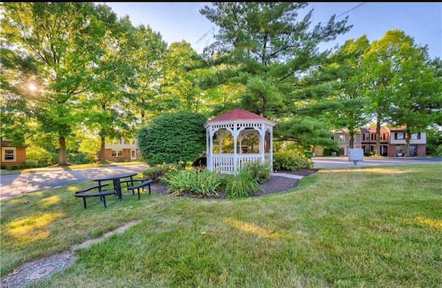 view of home's community with a gazebo and a yard