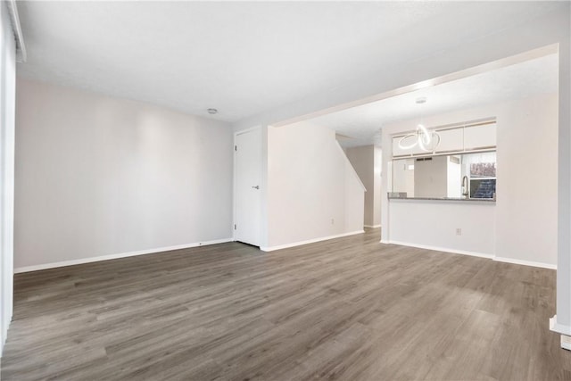 unfurnished living room with dark hardwood / wood-style flooring