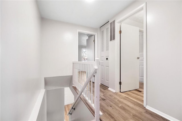 corridor with light hardwood / wood-style flooring