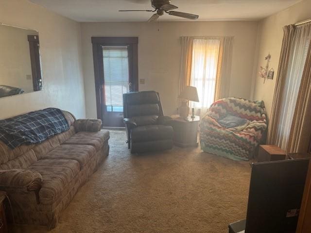 carpeted living room featuring ceiling fan