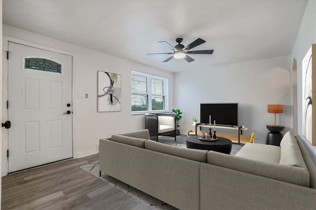 living room featuring ceiling fan and hardwood / wood-style flooring