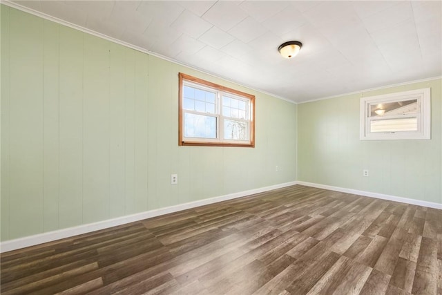 empty room featuring dark hardwood / wood-style flooring and crown molding