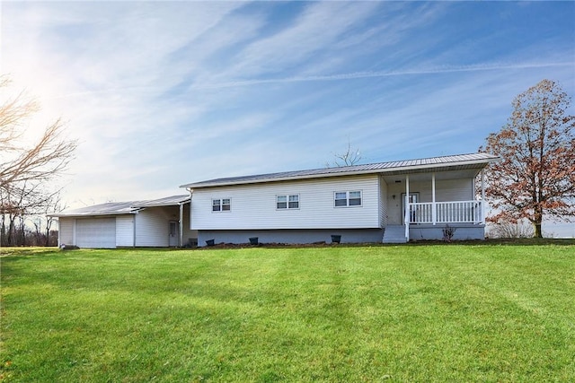 back of property with a lawn and covered porch