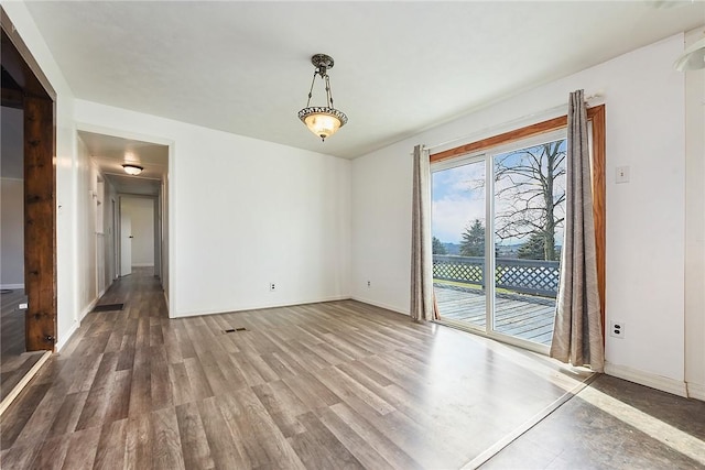 spare room with hardwood / wood-style floors