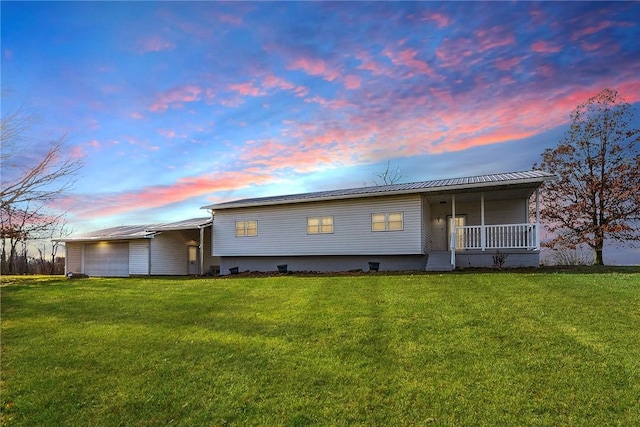 view of front of property with covered porch and a yard