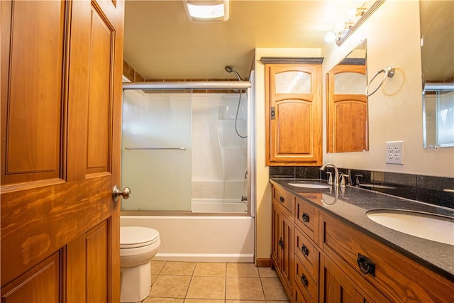 full bathroom with tile patterned flooring, vanity, enclosed tub / shower combo, and toilet