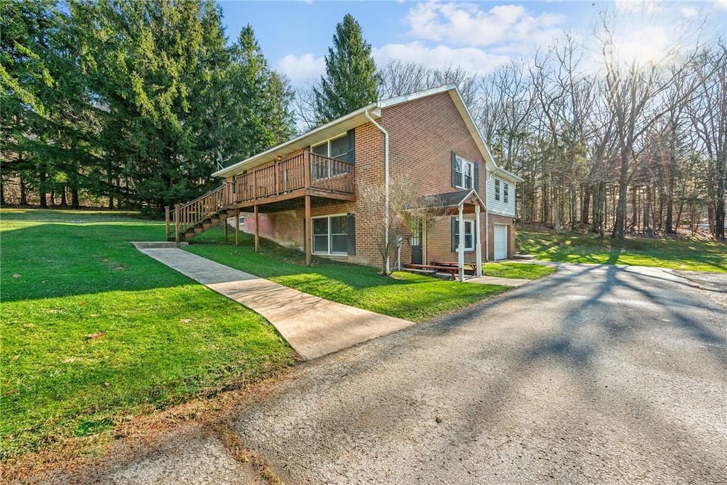 view of property exterior featuring a garage, a deck, and a lawn