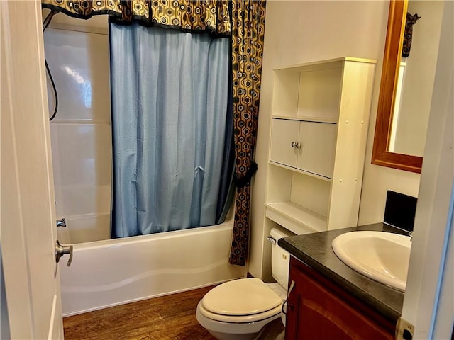 full bathroom featuring hardwood / wood-style floors, vanity, shower / bath combination with curtain, and toilet