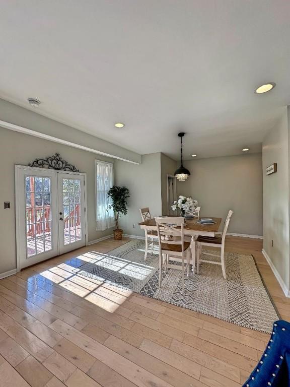 unfurnished dining area with french doors and light hardwood / wood-style flooring