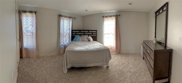 carpeted bedroom featuring vaulted ceiling