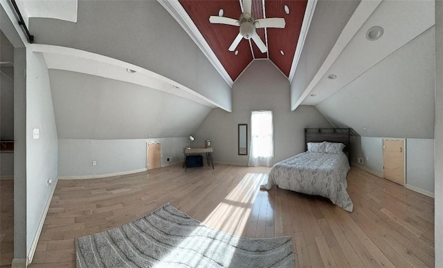 bedroom featuring light wood-type flooring, vaulted ceiling, and ceiling fan