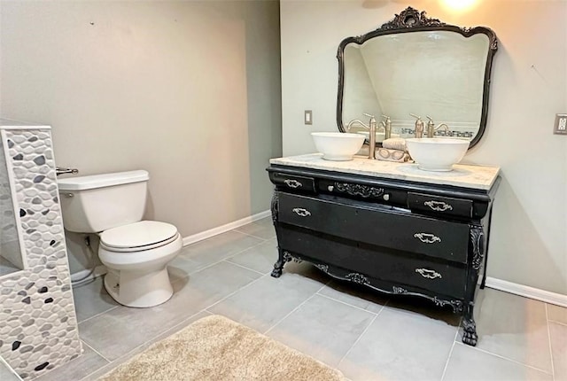 bathroom featuring tile patterned flooring, vanity, and toilet