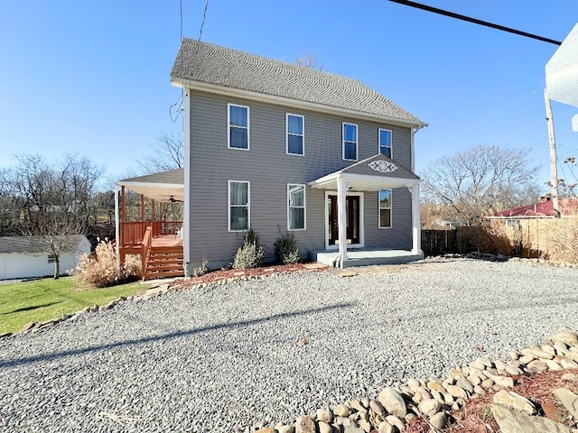 colonial-style house with a porch and ceiling fan