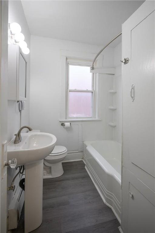 full bathroom with toilet, wood-type flooring, sink, and bathtub / shower combination