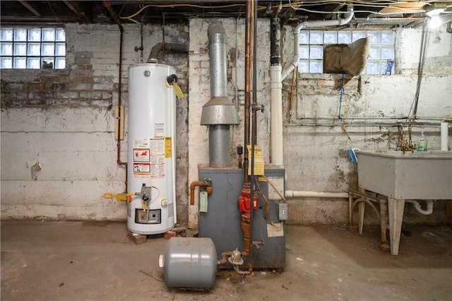 utility room featuring water heater and sink