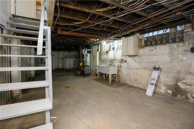 basement with gas water heater and sink