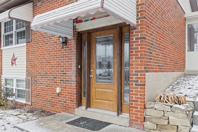 view of snow covered property entrance