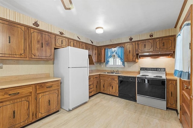 kitchen with sink, white appliances, and light wood-type flooring