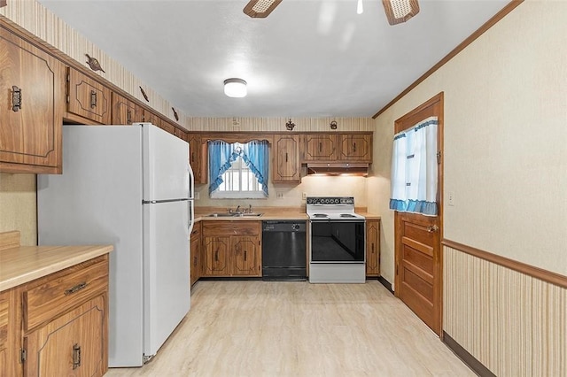 kitchen featuring light wood-type flooring, white appliances, ceiling fan, crown molding, and sink