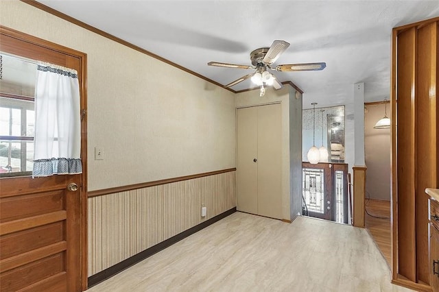 unfurnished room with light hardwood / wood-style floors, ceiling fan, and ornamental molding