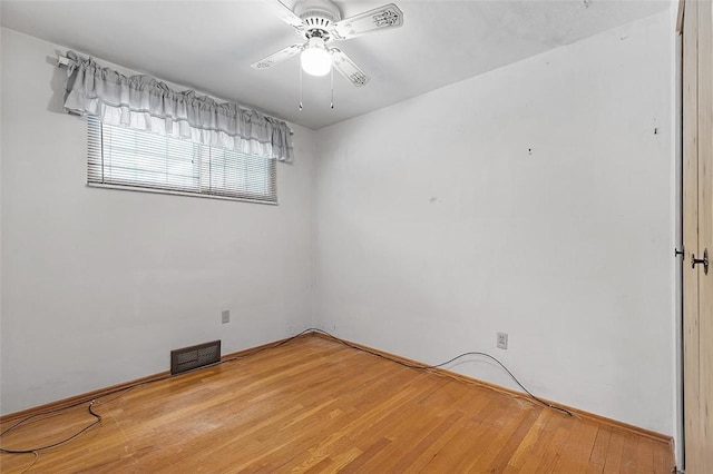 unfurnished room featuring hardwood / wood-style floors and ceiling fan