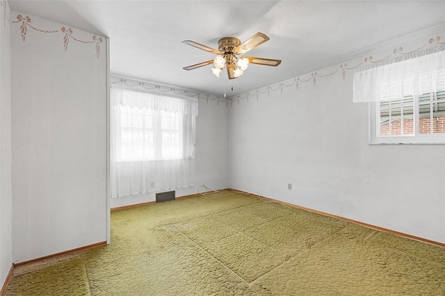 carpeted empty room featuring ceiling fan