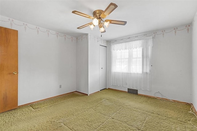 empty room with carpet floors and ceiling fan