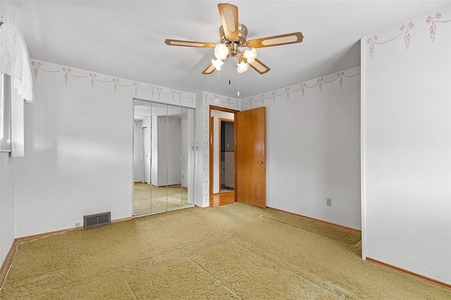 spare room with carpet and ceiling fan