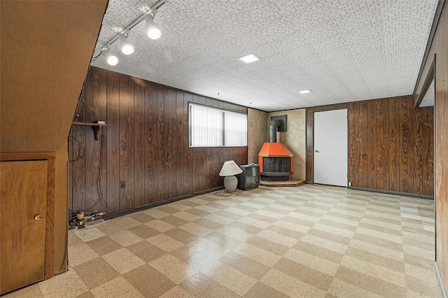 interior space with a wood stove and wood walls