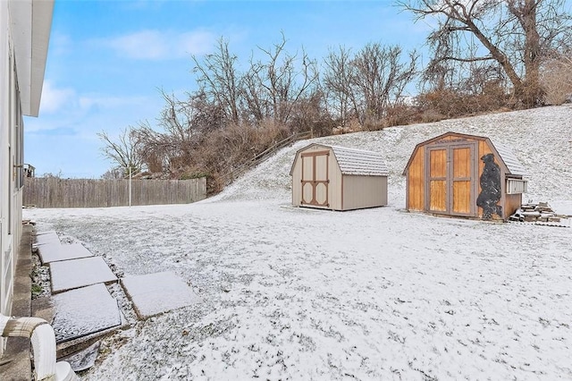 yard layered in snow with a storage unit