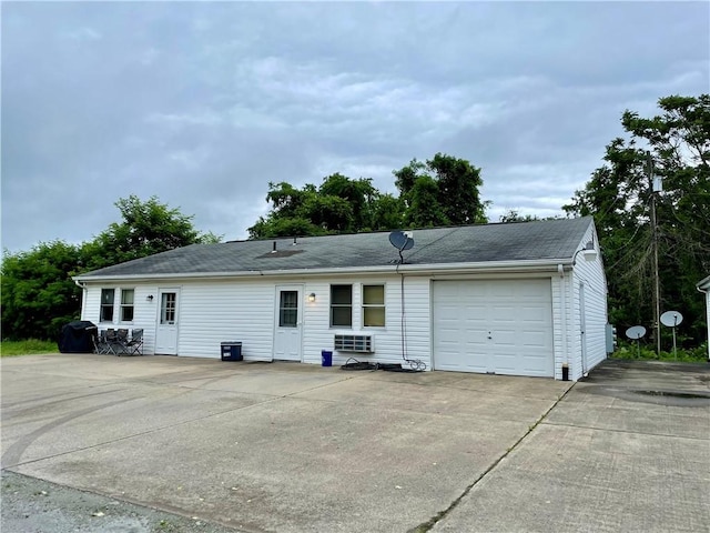 rear view of property with a garage