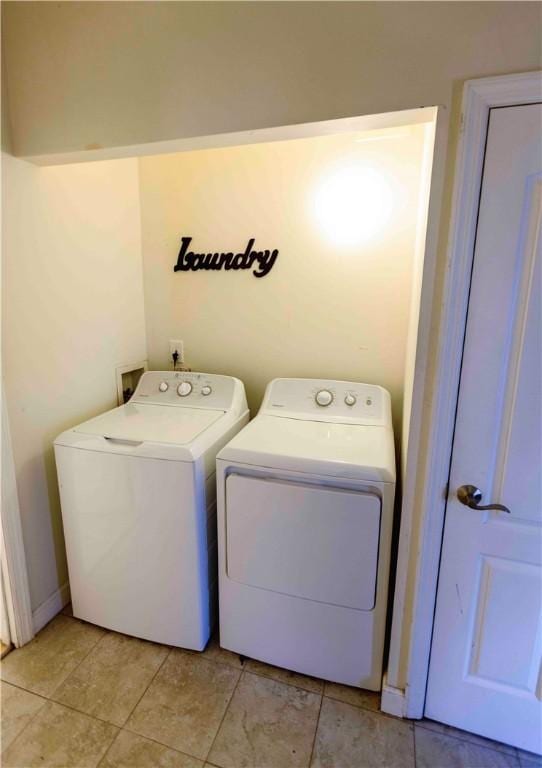 laundry area with light tile patterned floors and separate washer and dryer