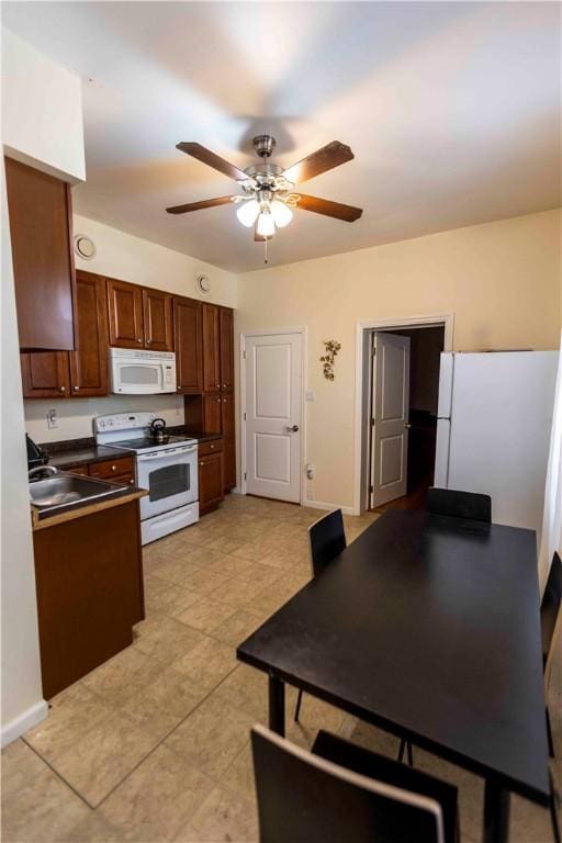 kitchen with ceiling fan, sink, and white appliances