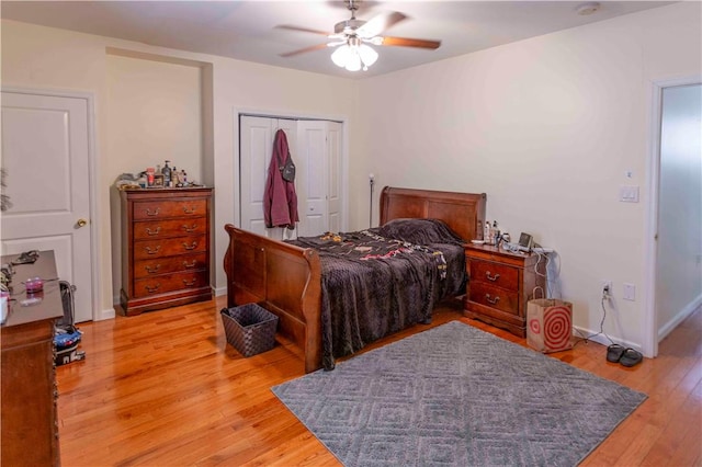 bedroom featuring light hardwood / wood-style flooring, a closet, and ceiling fan