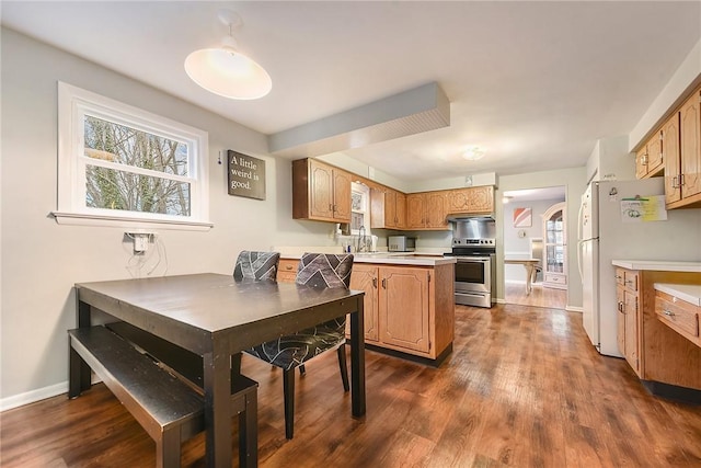 kitchen with sink, white fridge, dark wood-type flooring, and stainless steel electric range