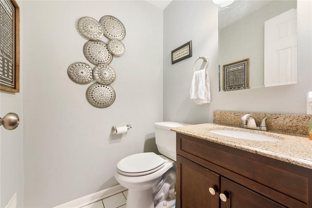 bathroom featuring tile patterned floors, vanity, and toilet