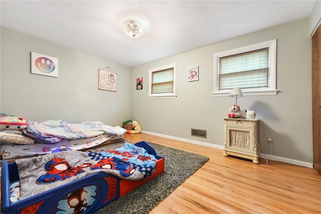 bedroom with wood-type flooring