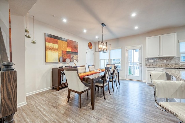 dining room featuring light hardwood / wood-style floors and a notable chandelier