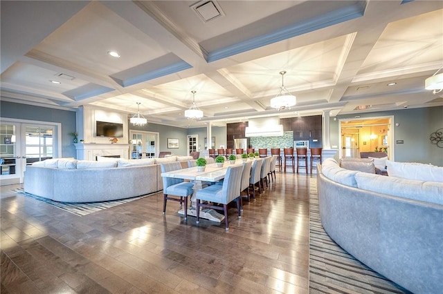 dining room featuring beam ceiling, ornamental molding, dark wood-type flooring, and coffered ceiling