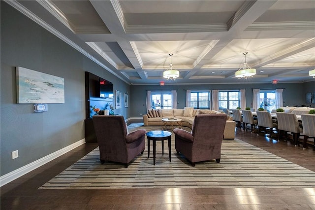 living room featuring a chandelier, beam ceiling, a healthy amount of sunlight, and coffered ceiling