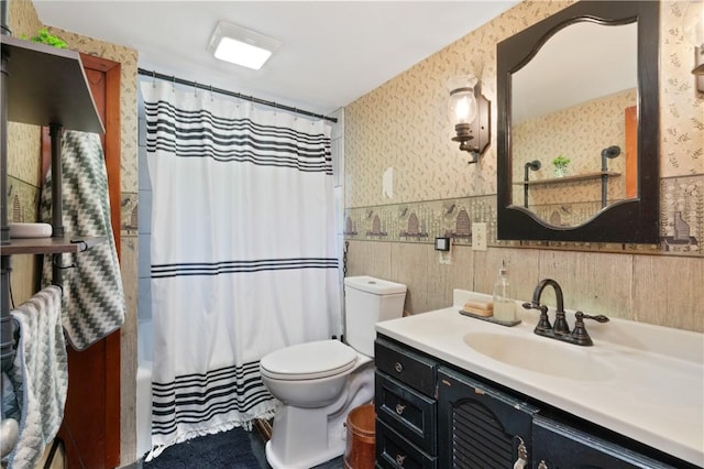 full bathroom featuring shower / bath combo, vanity, and toilet