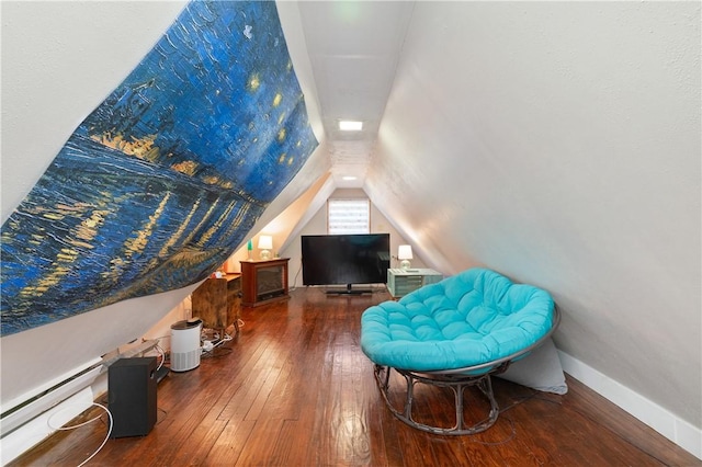 living area with hardwood / wood-style floors, a baseboard radiator, and lofted ceiling