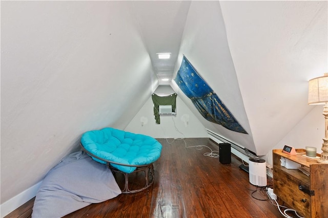 interior space with a wall unit AC, dark hardwood / wood-style flooring, a baseboard radiator, and lofted ceiling