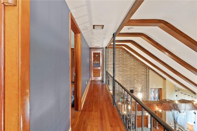 hall with hardwood / wood-style floors and lofted ceiling