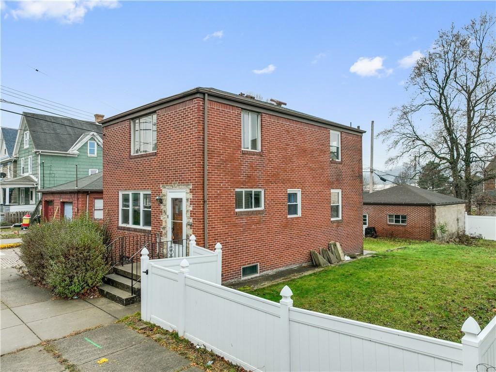 view of home's exterior with a yard