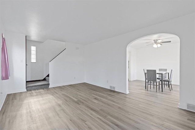 unfurnished living room featuring ceiling fan and light hardwood / wood-style floors